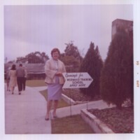 Weeki Wachee Tourist Standing Near Sign Advertising Mermaid Positions