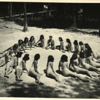 Weeki Wachee Mermaids Posing in a Circle on the Shore